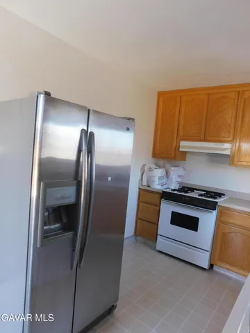 a kitchen with granite countertop stainless steel appliances and wooden cabinets