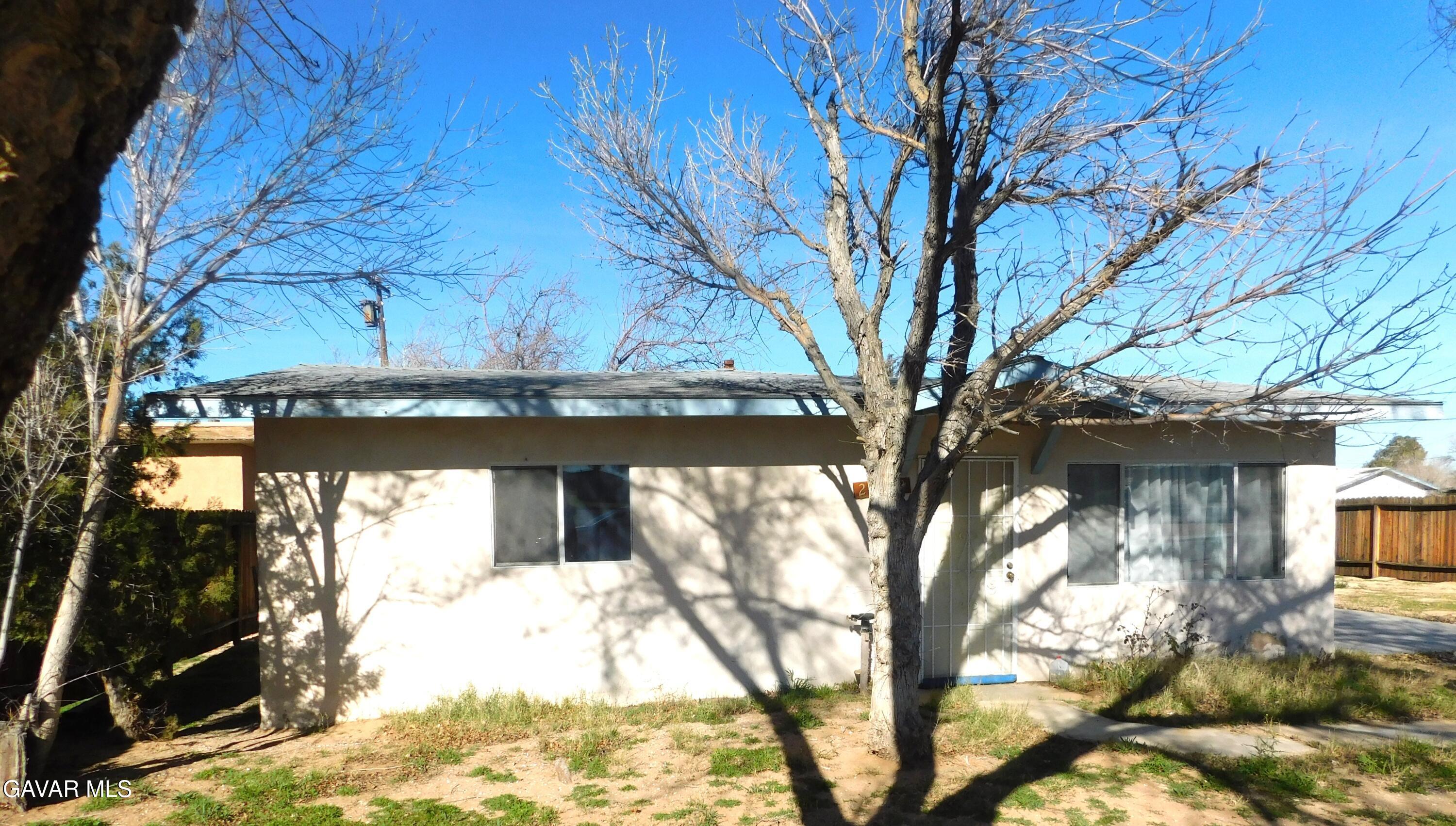 26933 John Street Boron, CA 93516 - Photo 2 of 26 a view of a tree in front of a house