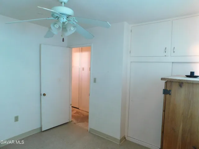 a view of a hallway with a refrigerator