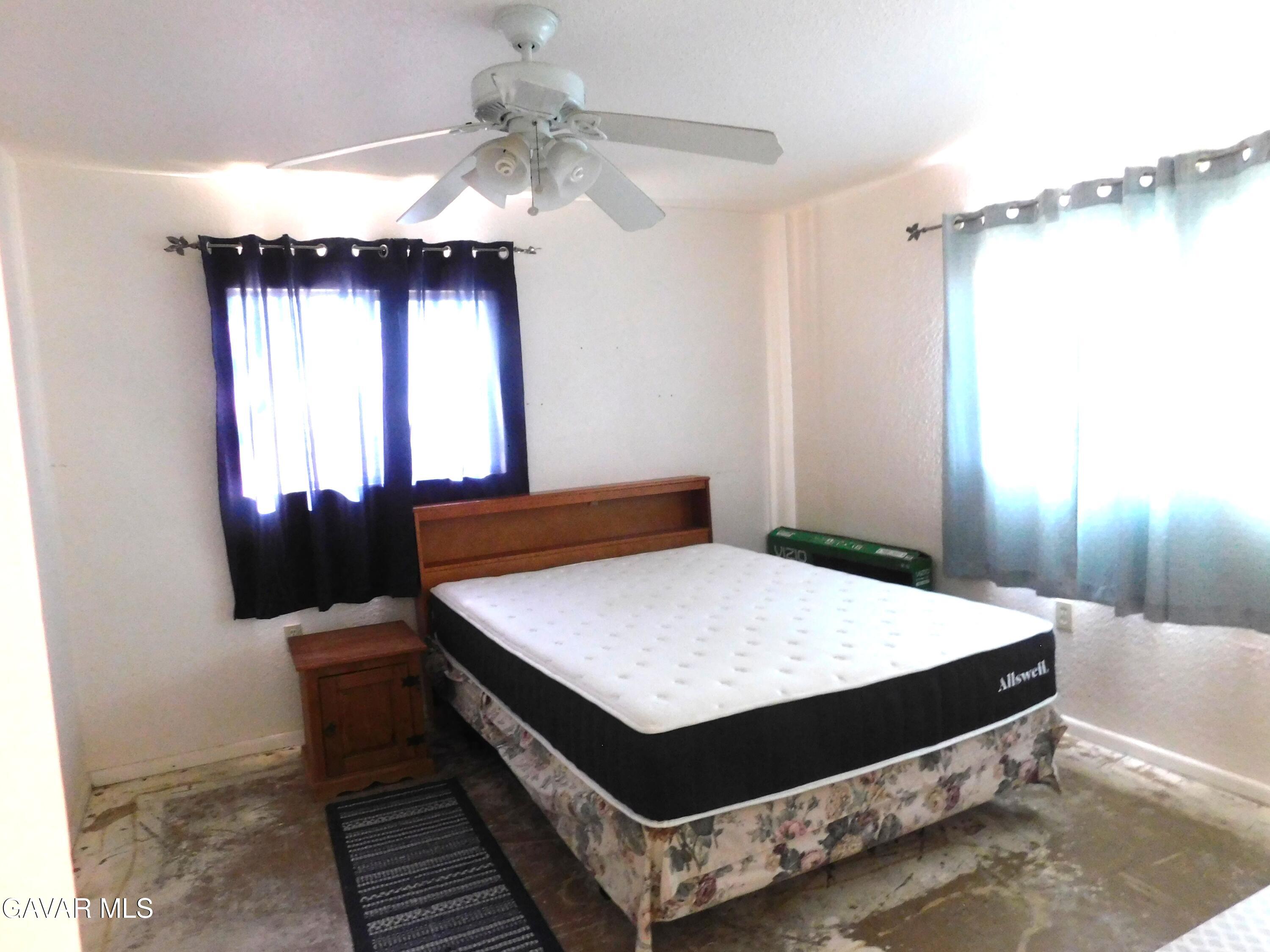 26933 John Street Boron, CA 93516 - Photo 23 of 26 a bedroom with a bed and a dresser