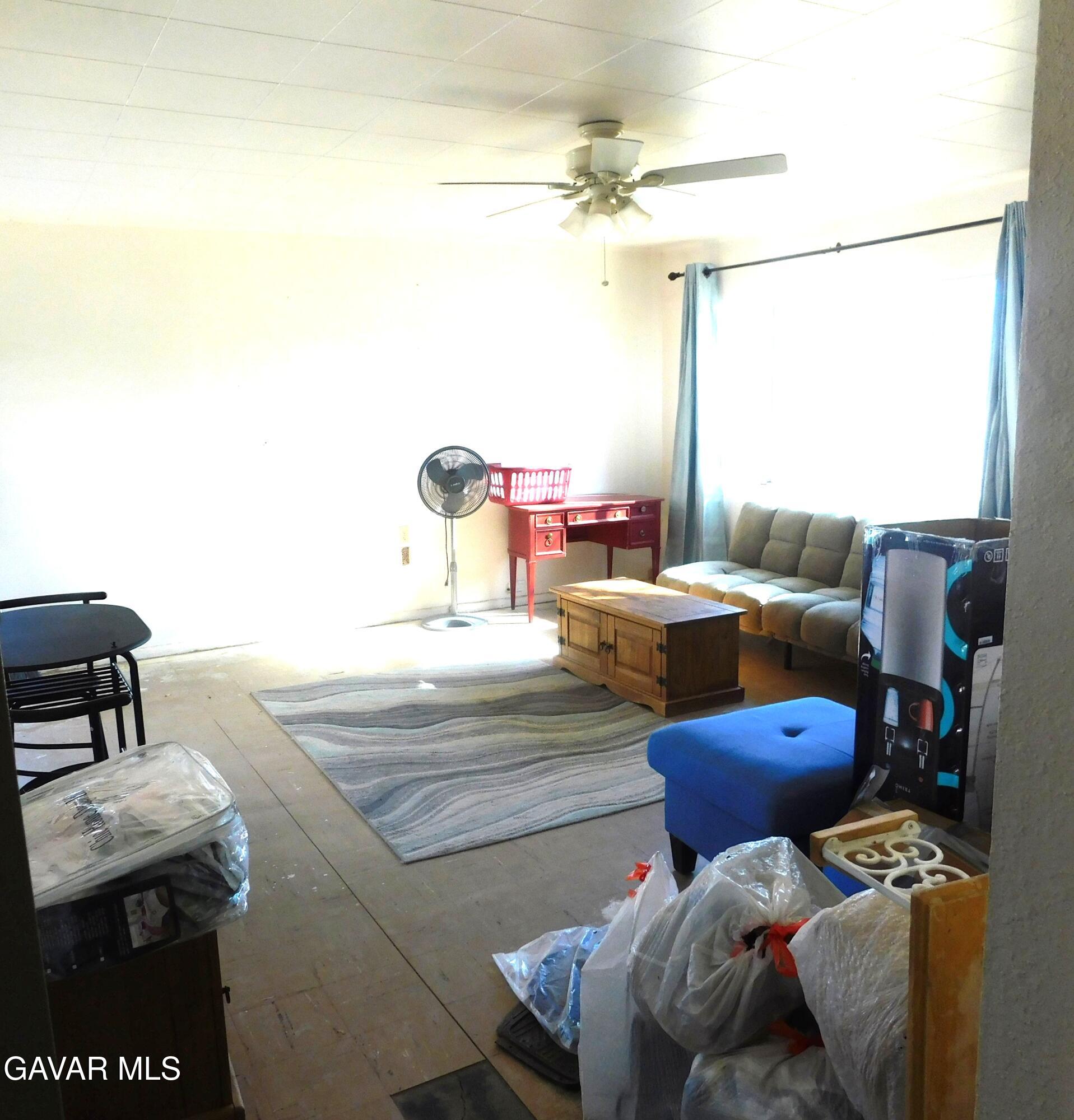 26933 John Street Boron, CA 93516 - Photo 25 of 26 a living room with furniture and a chandelier