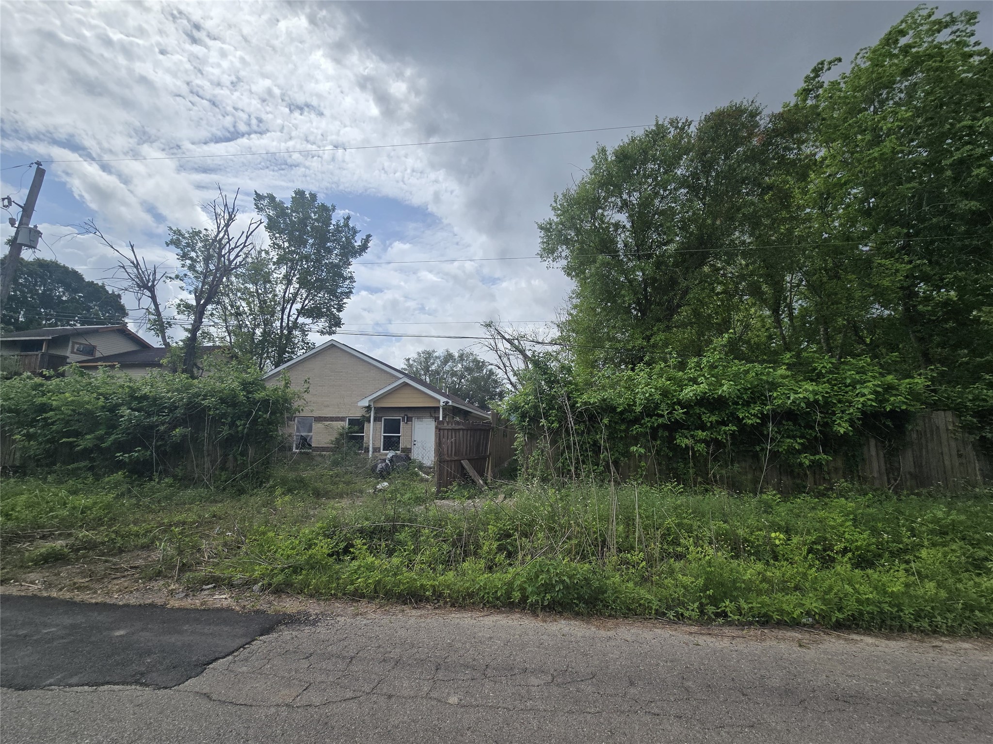 8930 Hollock Street Houston, TX 77075 - Photo 5 of 5 a front view of a house with a yard and green space