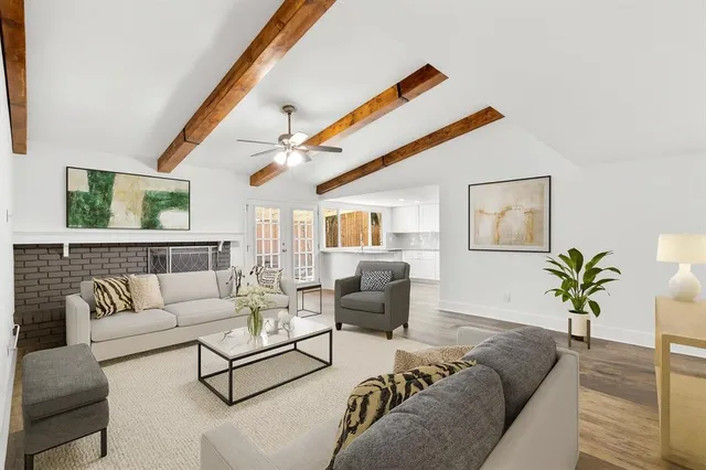 a living room with furniture and a potted plant