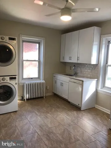 a kitchen with a stove a sink and a cabinets