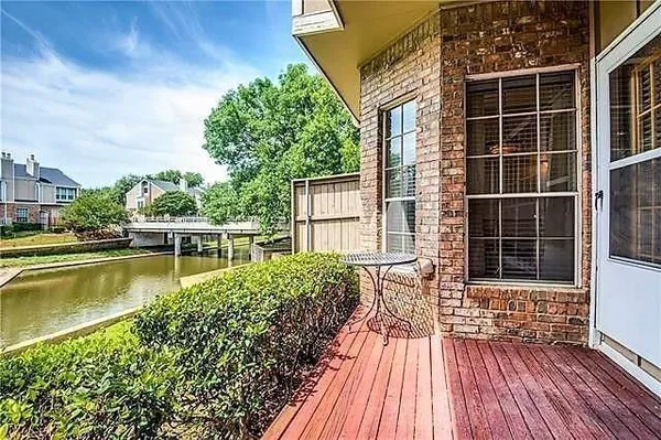 a view of a house with pool and wooden floor