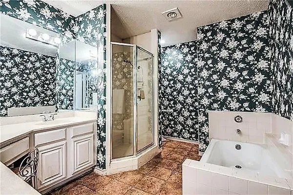 a bathroom with a bathtub and shower