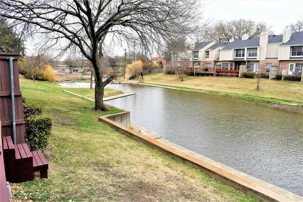 a view of a balcony with wooden floor and fence