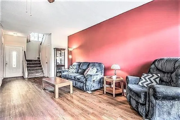 a view of a hallway with wooden floor and entryway