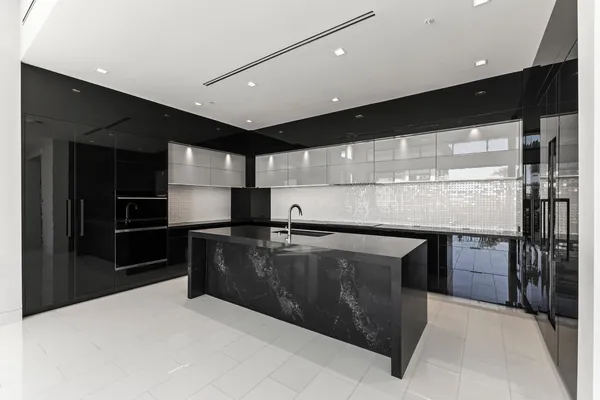 a view of kitchen with refrigerator and window