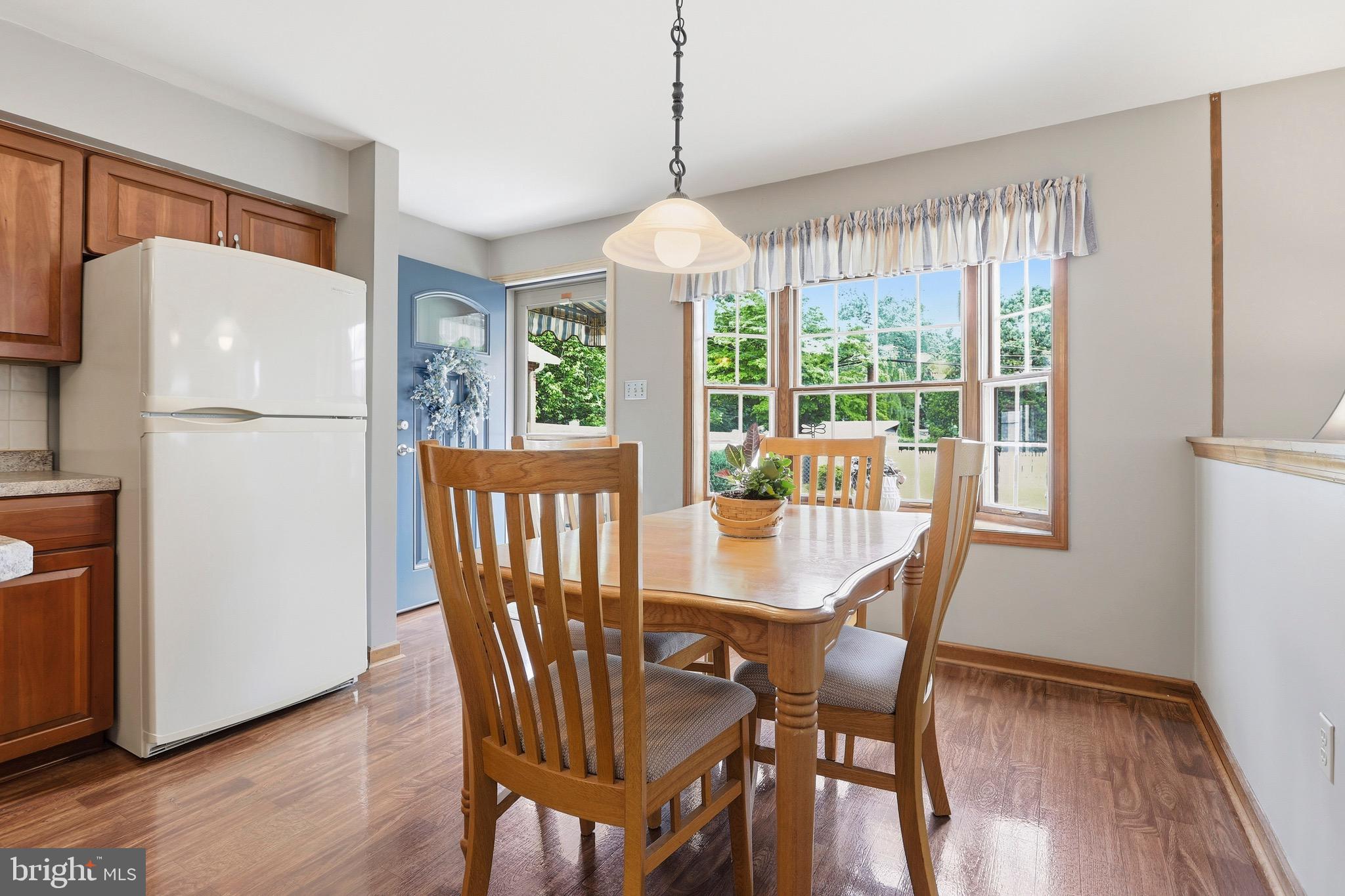 527 Saxer Avenue Springfield, PA 19064 - Photo 12 of 33 a dining room with furniture a chandelier and wooden floor