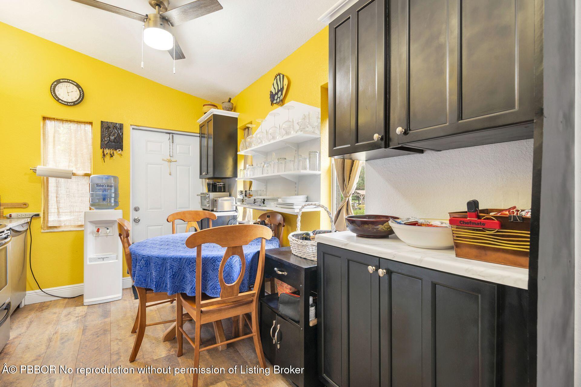 2770 E Road Loxahatchee, FL 33470 - Photo 31 of 51 a view of a kitchen with a table and chairs