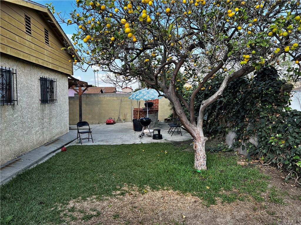 1506 South Grandee Avenue Compton, CA 90220 - Photo 34 of 35 a view of a white house in front of a big yard with large trees