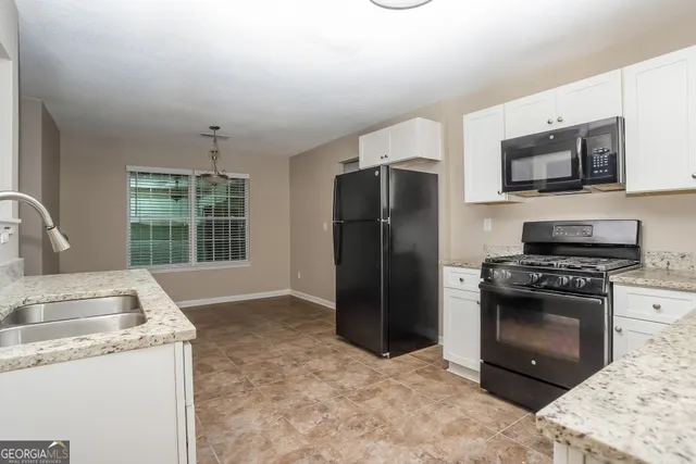 a kitchen with a stove and a refrigerator