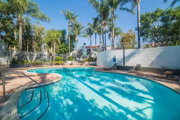 a swimming pool with outdoor seating and yard