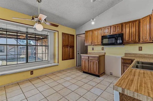 a kitchen with a sink and a stove top oven