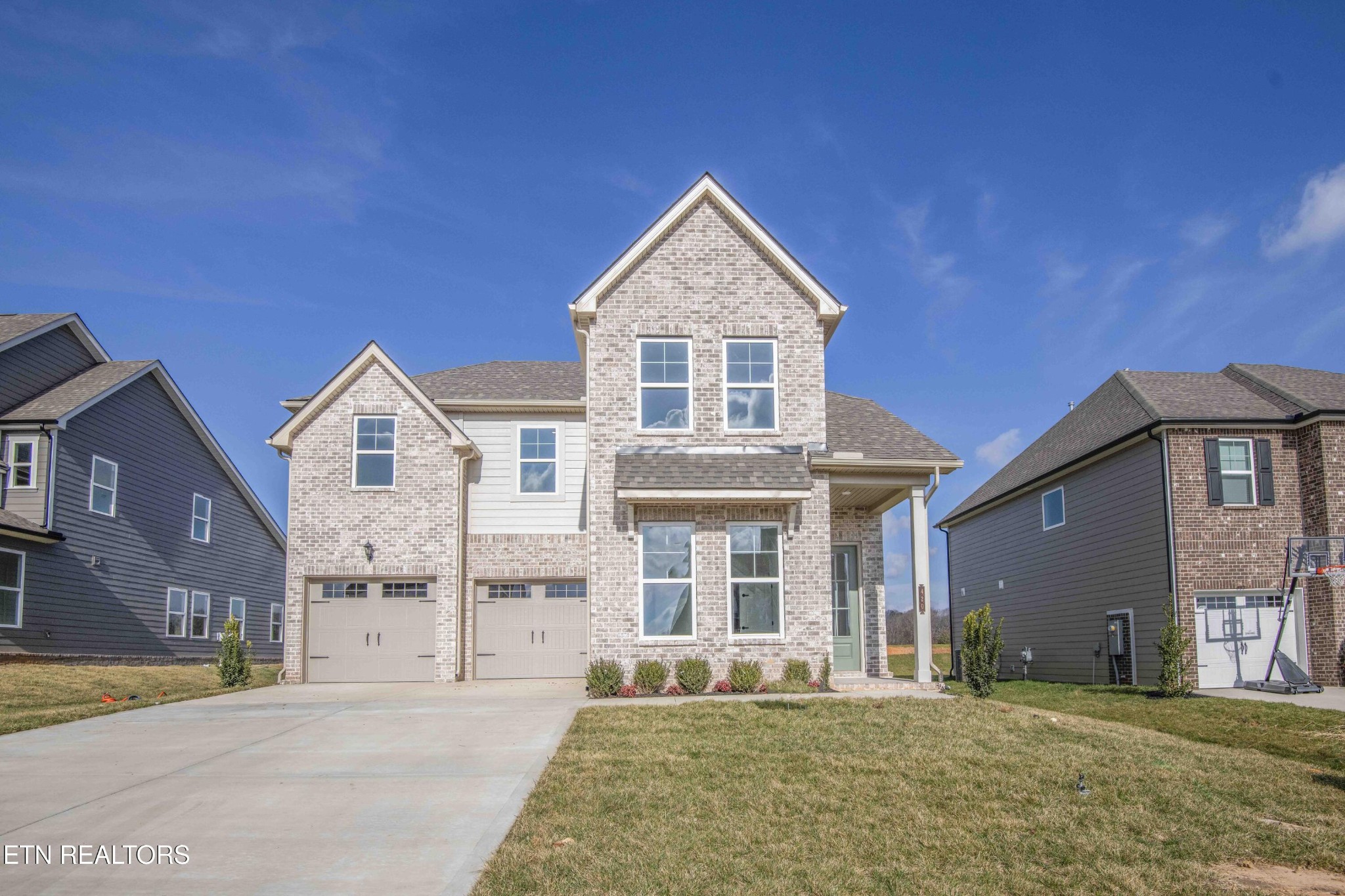 a front view of a house with a yard