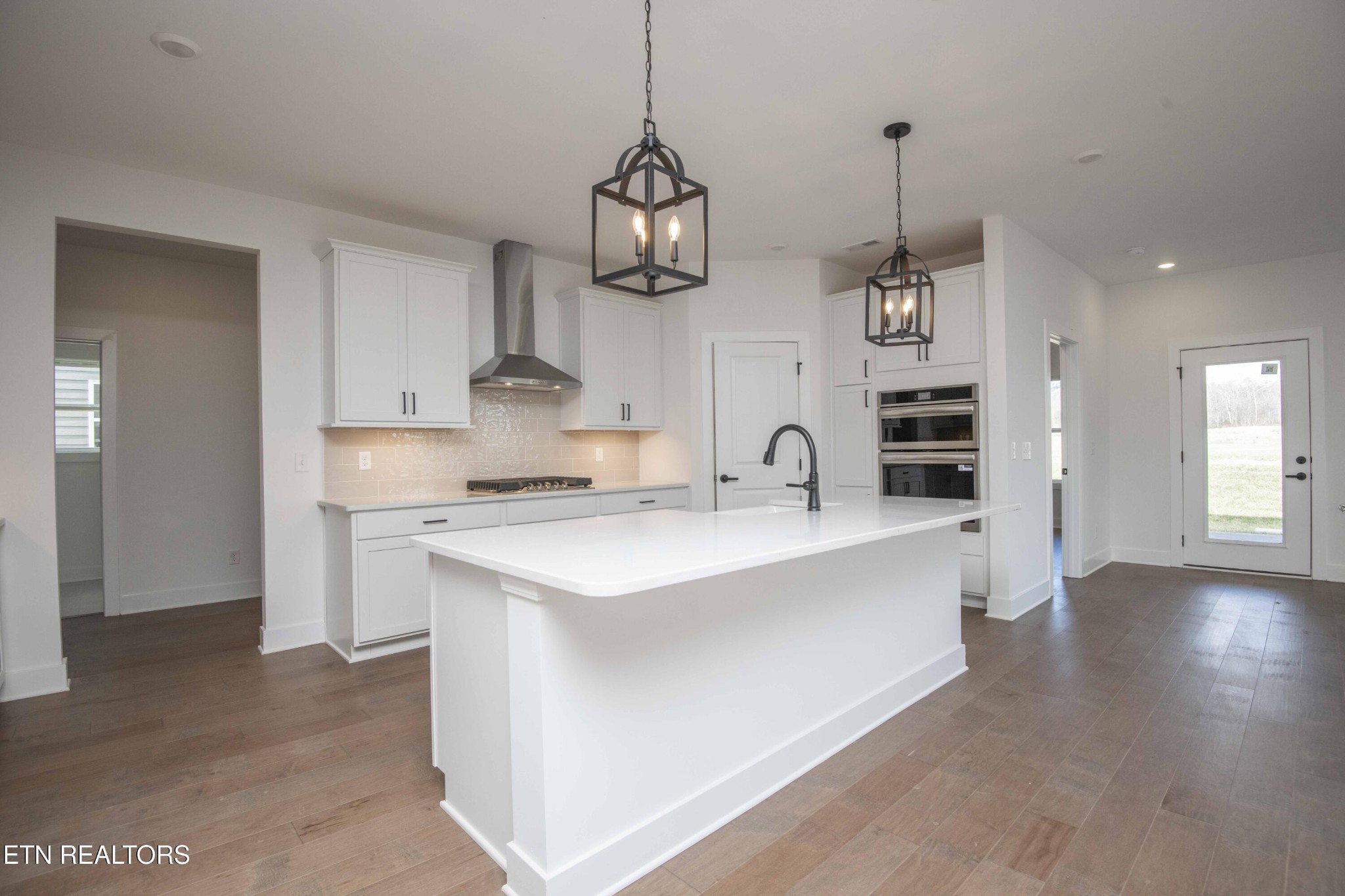 420 Ivey Farms Road Knoxville, TN 37934 - Photo 14 of 56 a kitchen with stainless steel appliances granite countertop a sink a stove a refrigerator and island with wooden floor