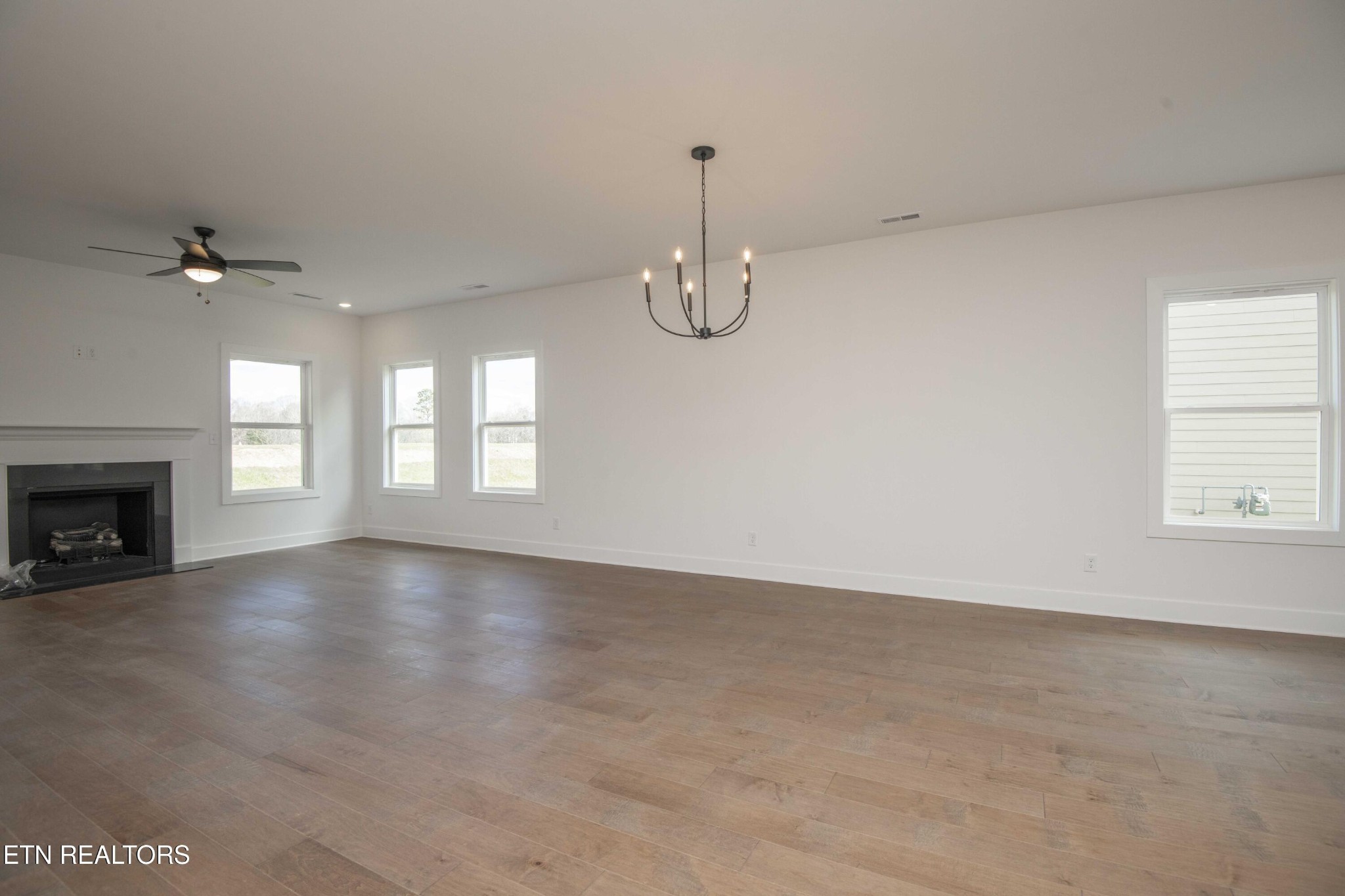 420 Ivey Farms Road Knoxville, TN 37934 - Photo 22 of 56 a view of an empty room with a fireplace and a window