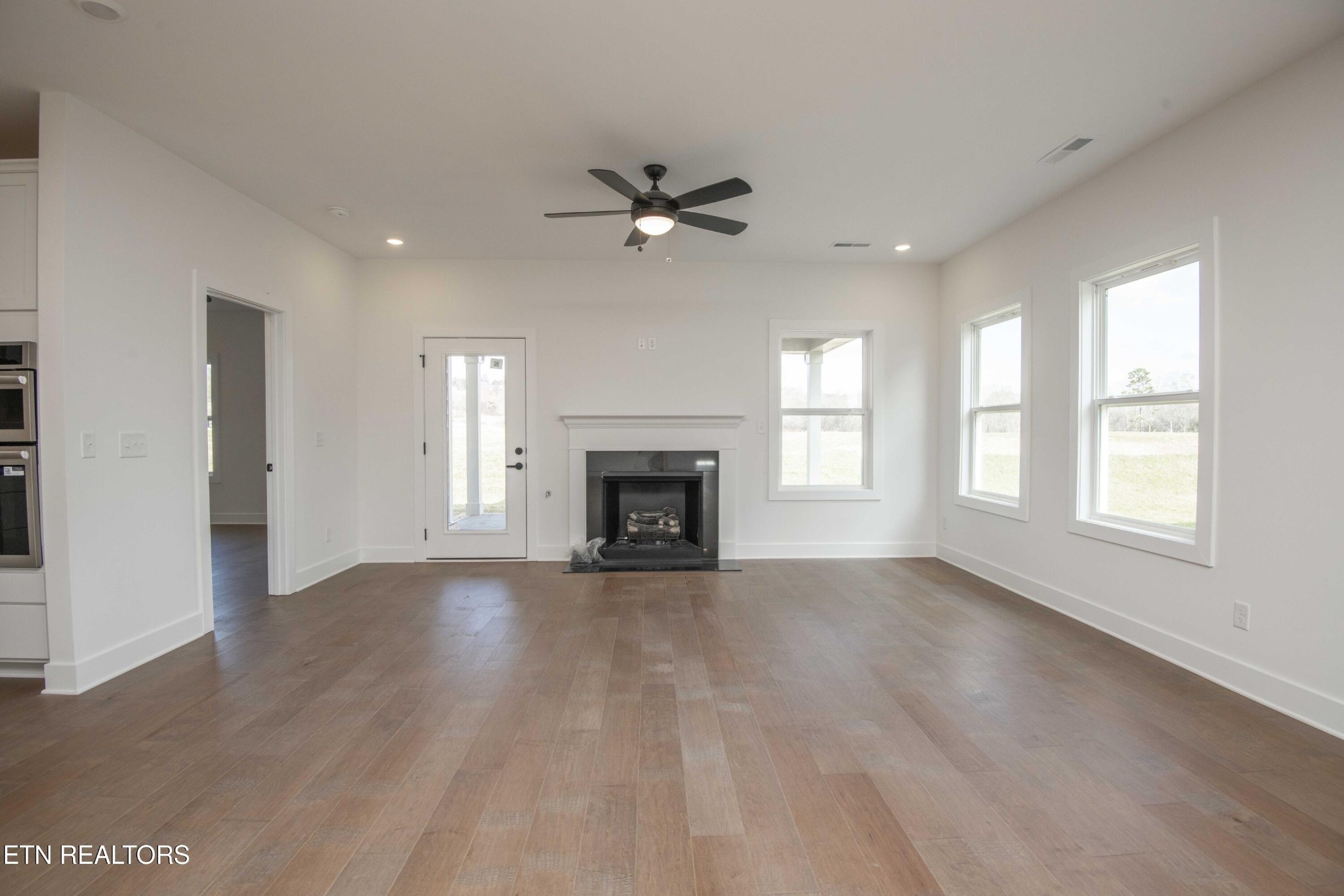 420 Ivey Farms Road Knoxville, TN 37934 - Photo 23 of 56 an empty room with chandelier fan and windows