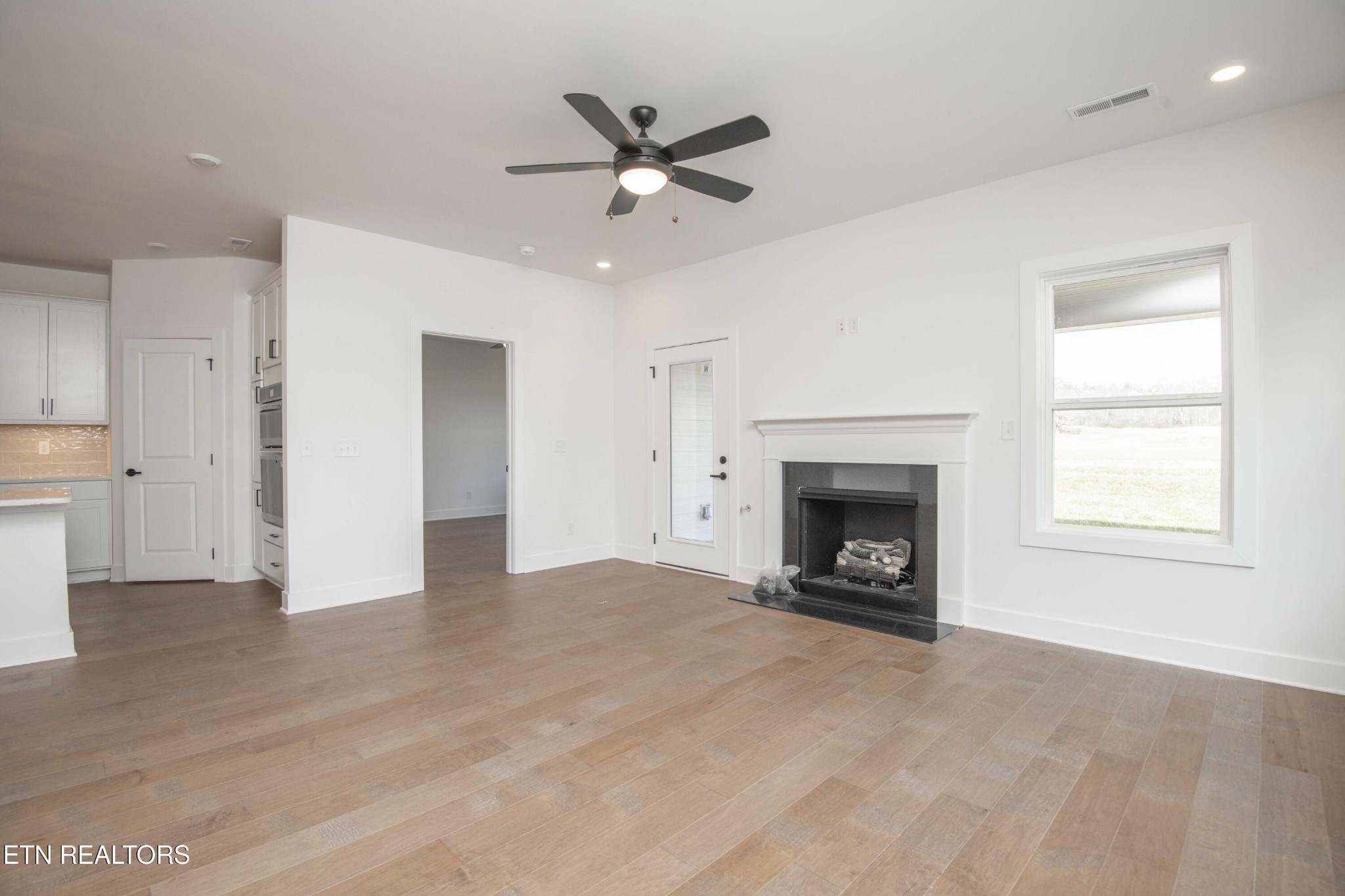 420 Ivey Farms Road Knoxville, TN 37934 - Photo 24 of 56 a view of an empty room with a fireplace and a window