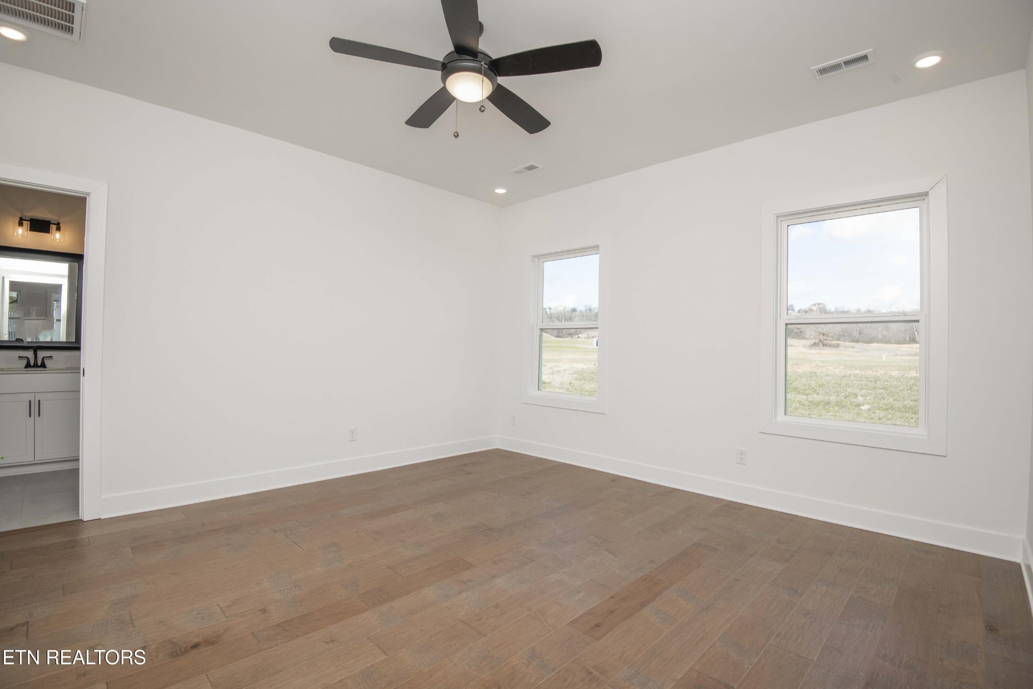 420 Ivey Farms Road Knoxville, TN 37934 - Photo 27 of 56 en empty room with windows and ceiling fan