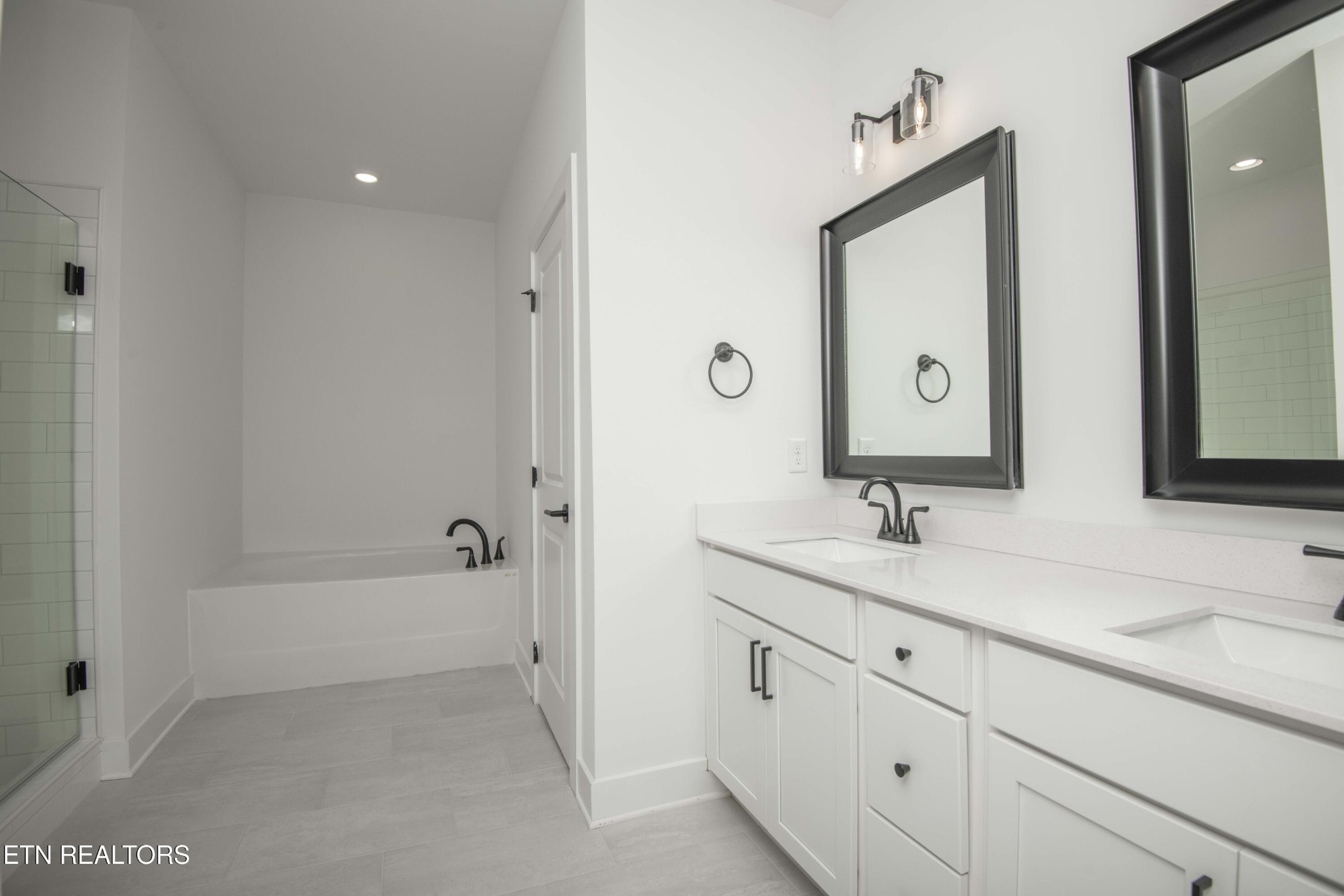 420 Ivey Farms Road Knoxville, TN 37934 - Photo 29 of 56 a bathroom with a bathtub a double vanity sink and mirror
