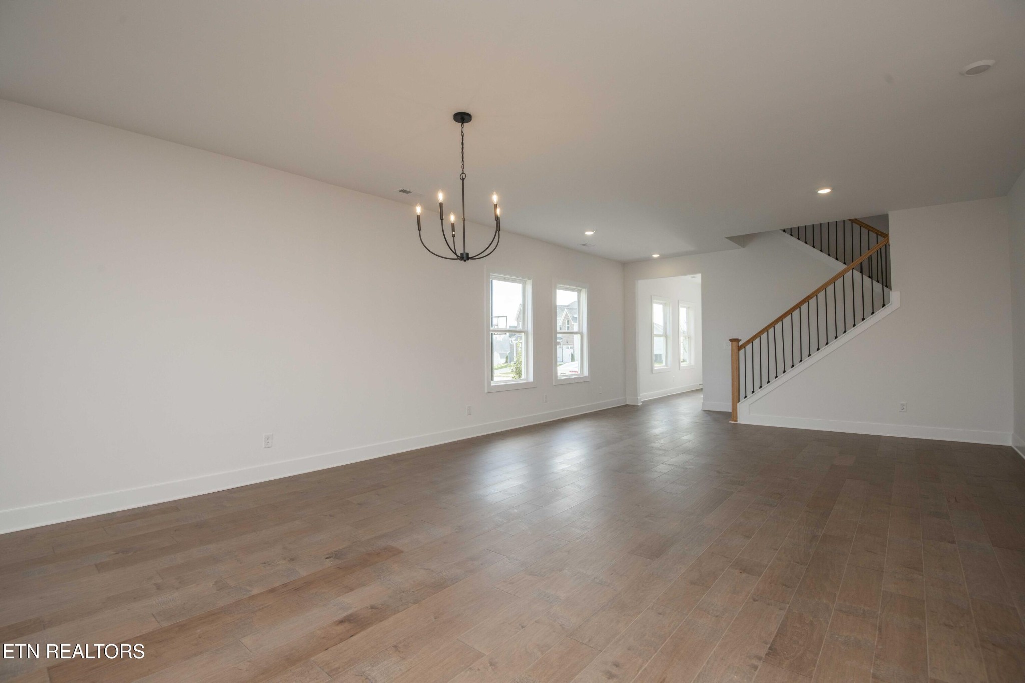 420 Ivey Farms Road Knoxville, TN 37934 - Photo 10 of 56 an empty room with wooden floor and chandelier