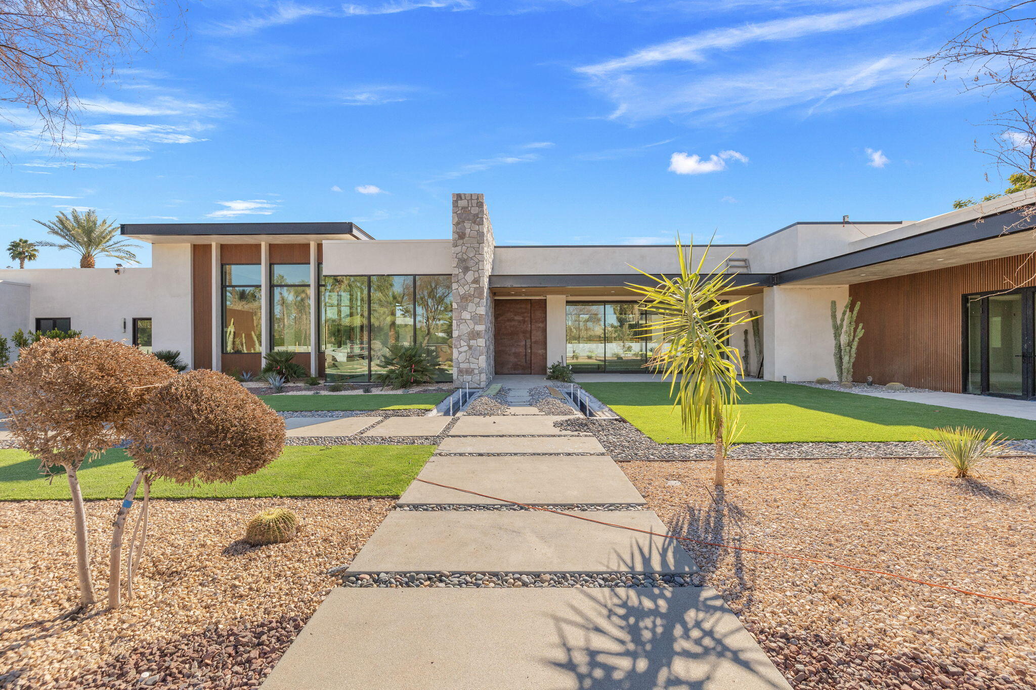 a view of house with swimming pool outdoor seating