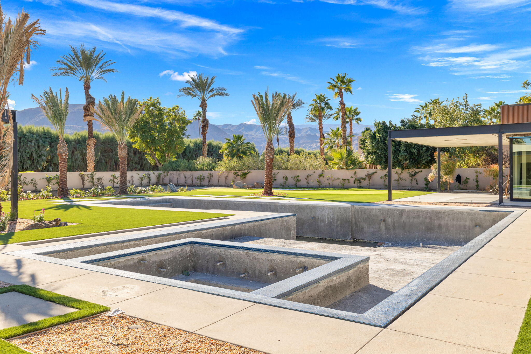 3 Shakespeare Court Rancho Mirage, CA 92270 - Photo 29 of 35 a view of a swimming pool with an outdoor seating