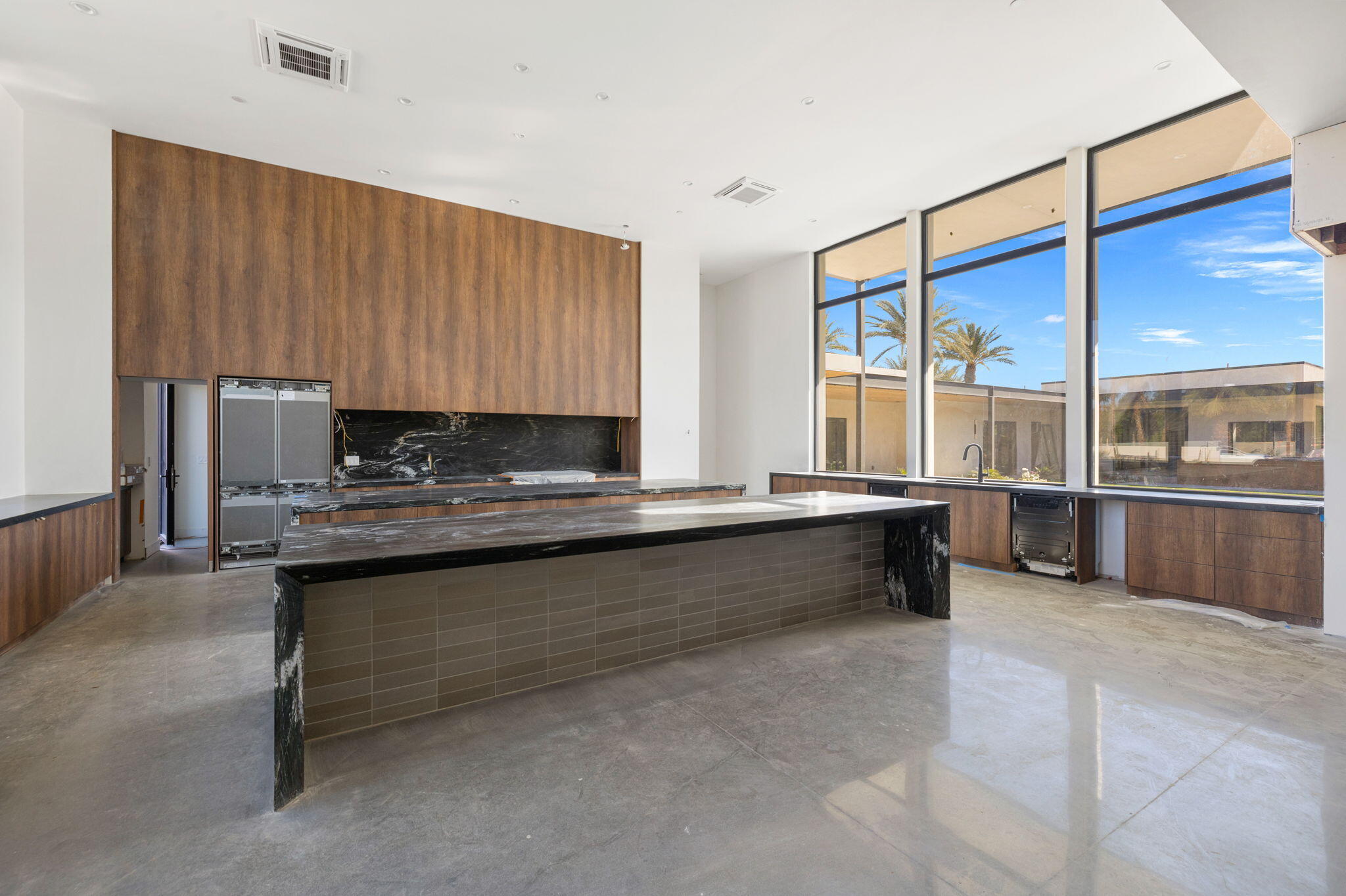 3 Shakespeare Court Rancho Mirage, CA 92270 - Photo 6 of 35 a large kitchen with kitchen island granite countertop a sink and a refrigerator