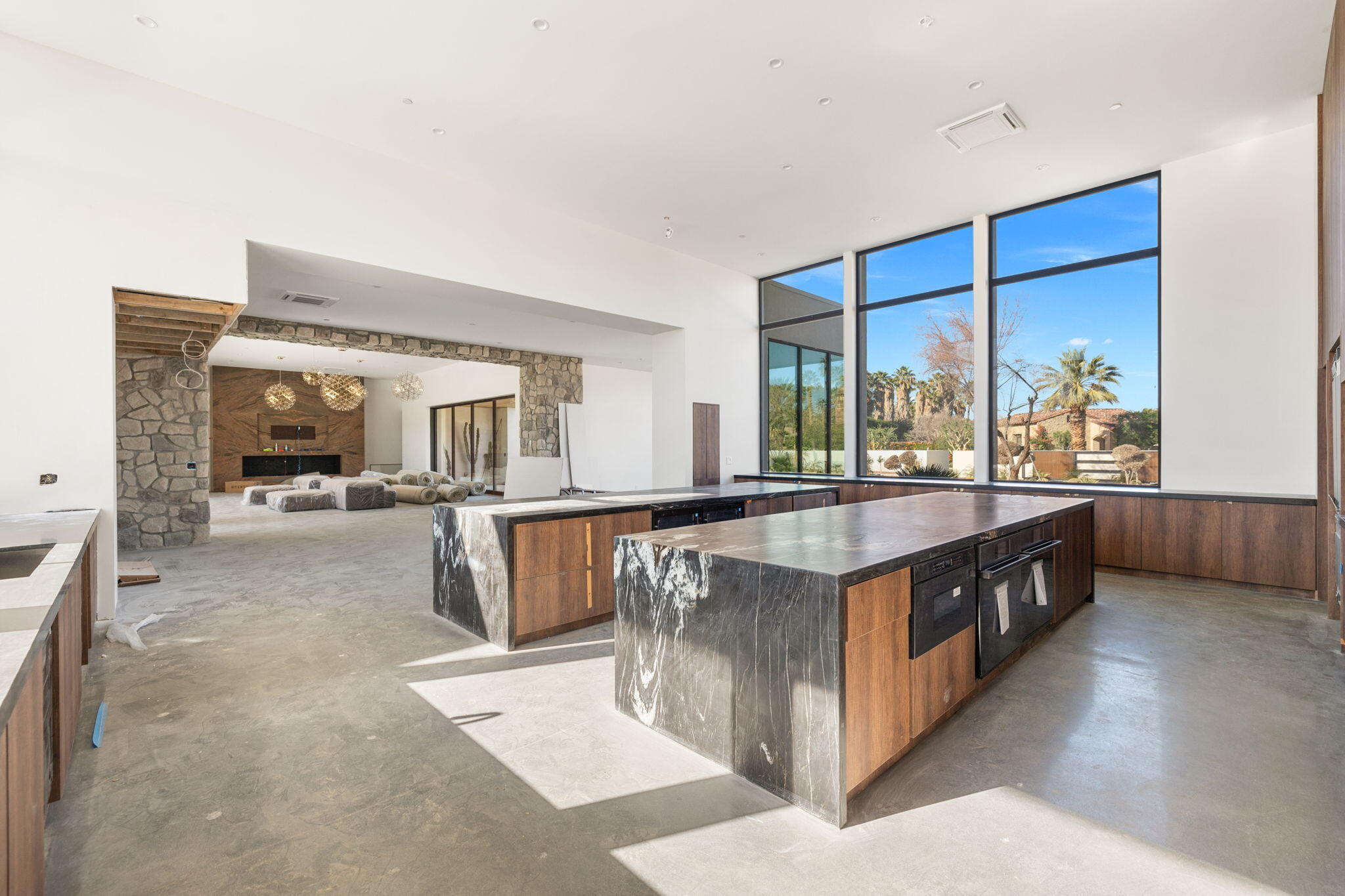3 Shakespeare Court Rancho Mirage, CA 92270 - Photo 7 of 35 a open kitchen with stainless steel appliances granite countertop a large counter top and a stove