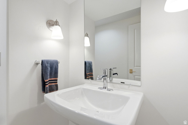 71 Farm Road Midway, UT 84049 - Photo 46 of 92 Pedestal sink with chrome faucet, framed mirror, and wall-mounted sconce lighting