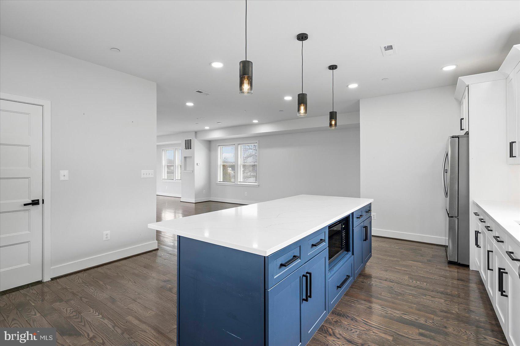 11030 Bird River Grove Road White Marsh, MD 21162 - Photo 20 of 53 a kitchen with kitchen island a sink a stove and a refrigerator