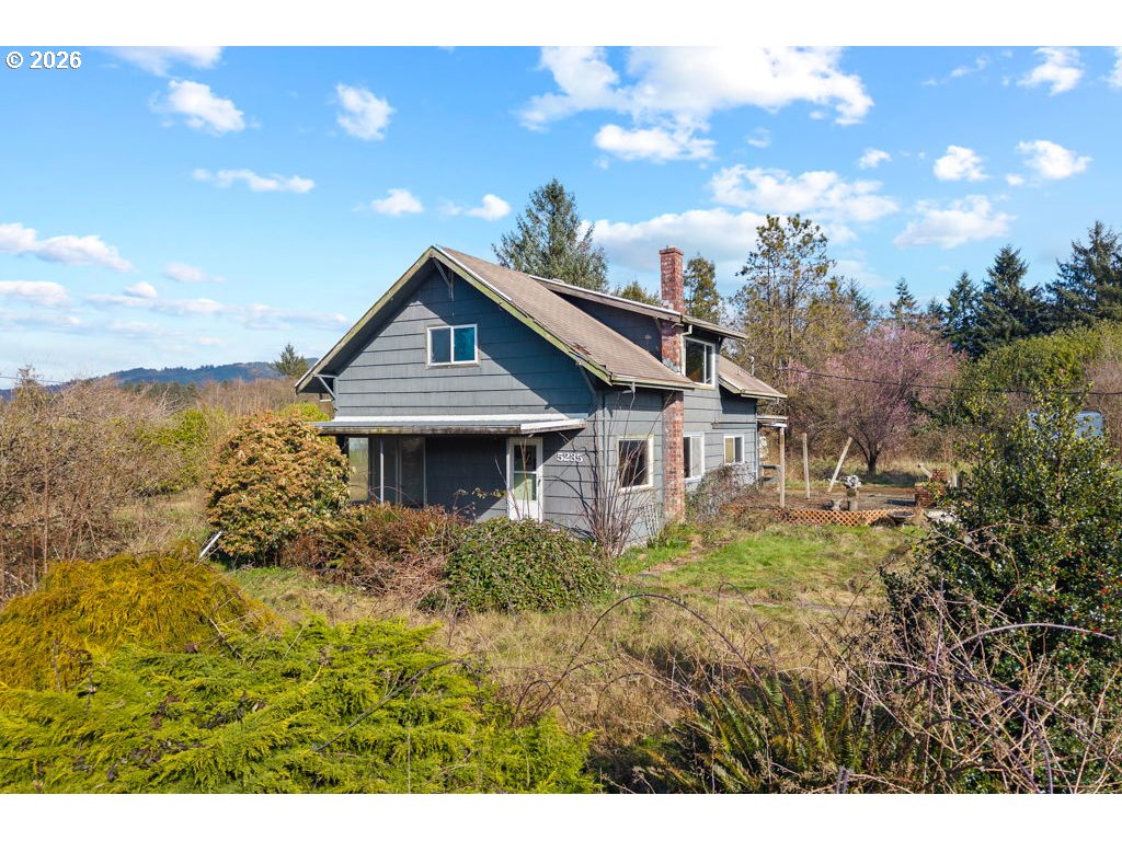 5235 Brickyard Road Tillamook, OR 97141 - Photo 1 of 14 a front view of house with yard and trees in the background