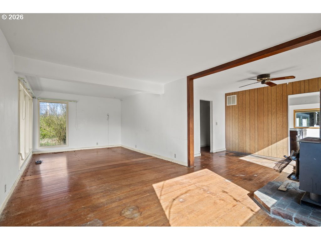 5235 Brickyard Road Tillamook, OR 97141 - Photo 3 of 14 a view of an empty room and window and wooden floor