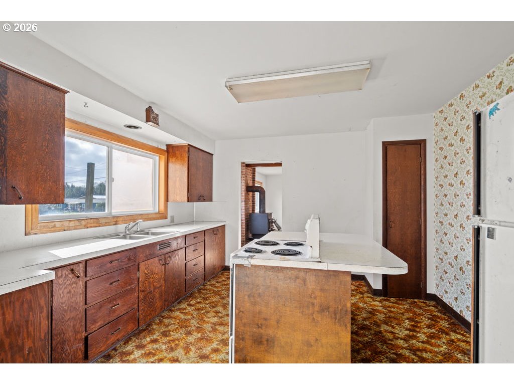 5235 Brickyard Road Tillamook, OR 97141 - Photo 7 of 14 a kitchen with stainless steel appliances granite countertop a sink stove and cabinets