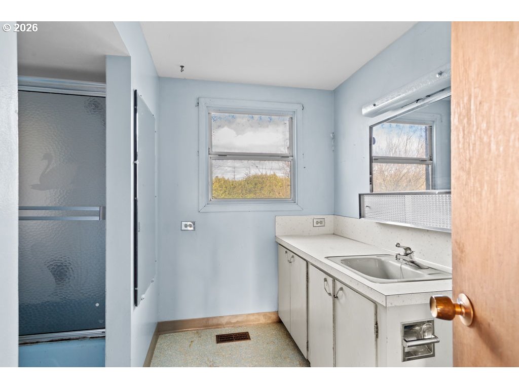 5235 Brickyard Road Tillamook, OR 97141 - Photo 9 of 14 a bathroom with a sink a toilet and a window