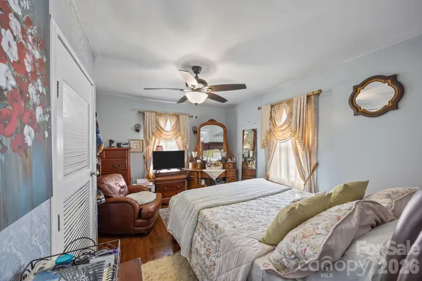 a bedroom with a bed and window