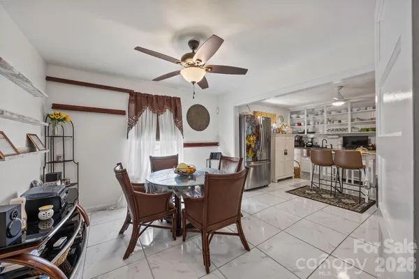 a dining room with furniture and wooden floor