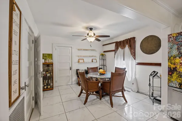 a view of a dining room with furniture and chandelier