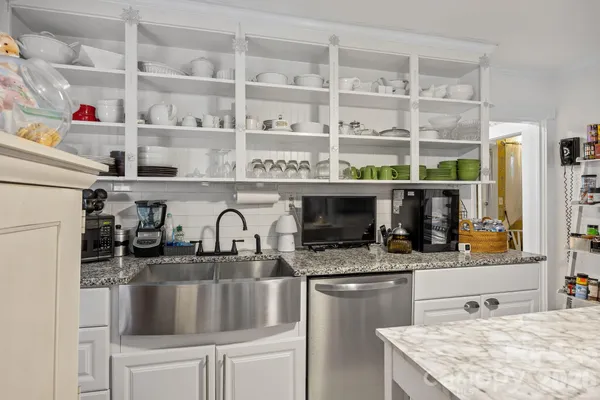 a kitchen with stainless steel appliances granite countertop a sink and cabinets