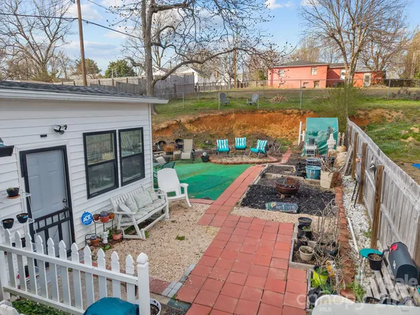 a view of a chairs and table in patio with a yard