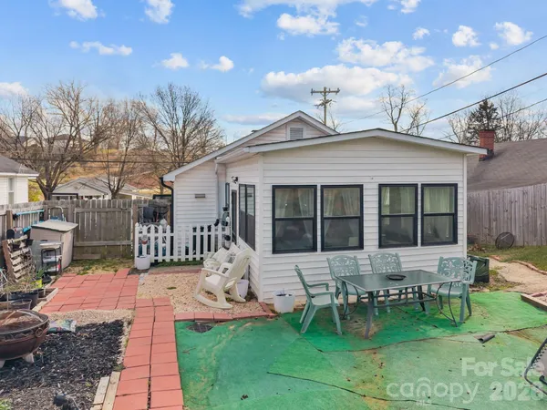 a front view of a house with a yard patio and outdoor seating