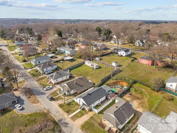 an aerial view of residential building with parking