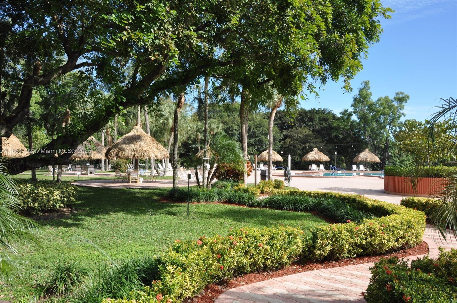 3090 Holiday Springs Boulevard, Unit 206 Margate, FL 33063 - Photo 12 of 41 a view of a park with large trees