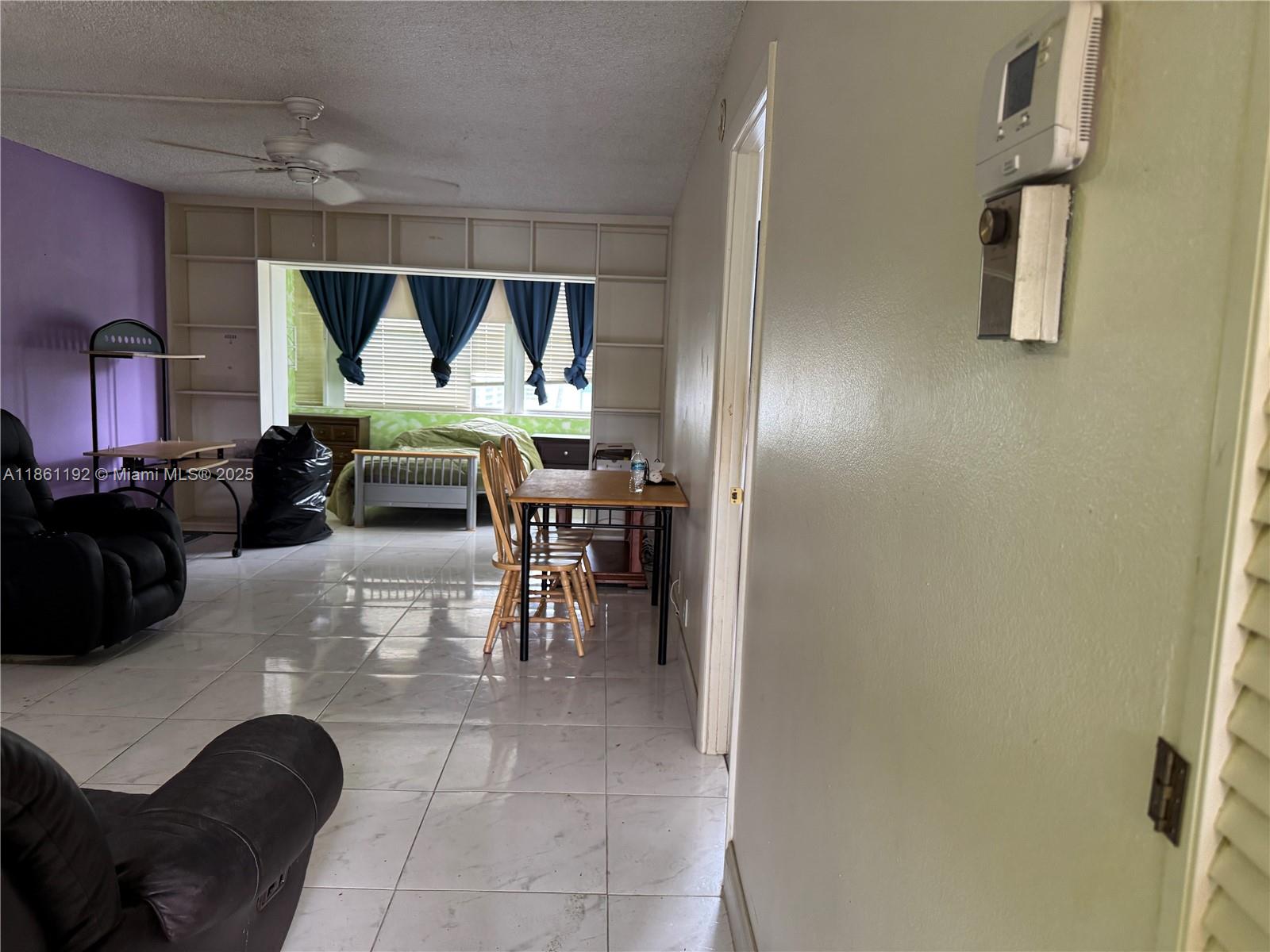 3090 Holiday Springs Boulevard, Unit 206 Margate, FL 33063 - Photo 17 of 41 a dining room with furniture and a window