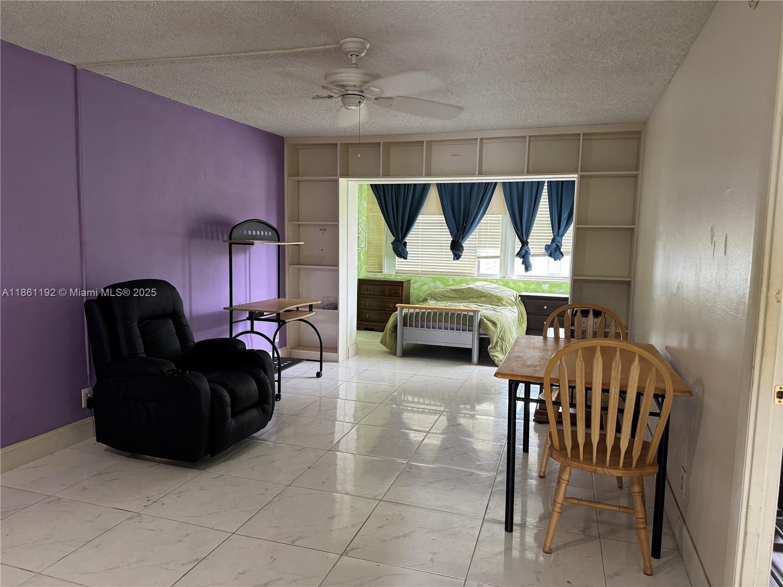 3090 Holiday Springs Boulevard, Unit 206 Margate, FL 33063 - Photo 18 of 41 a living room with furniture and a window