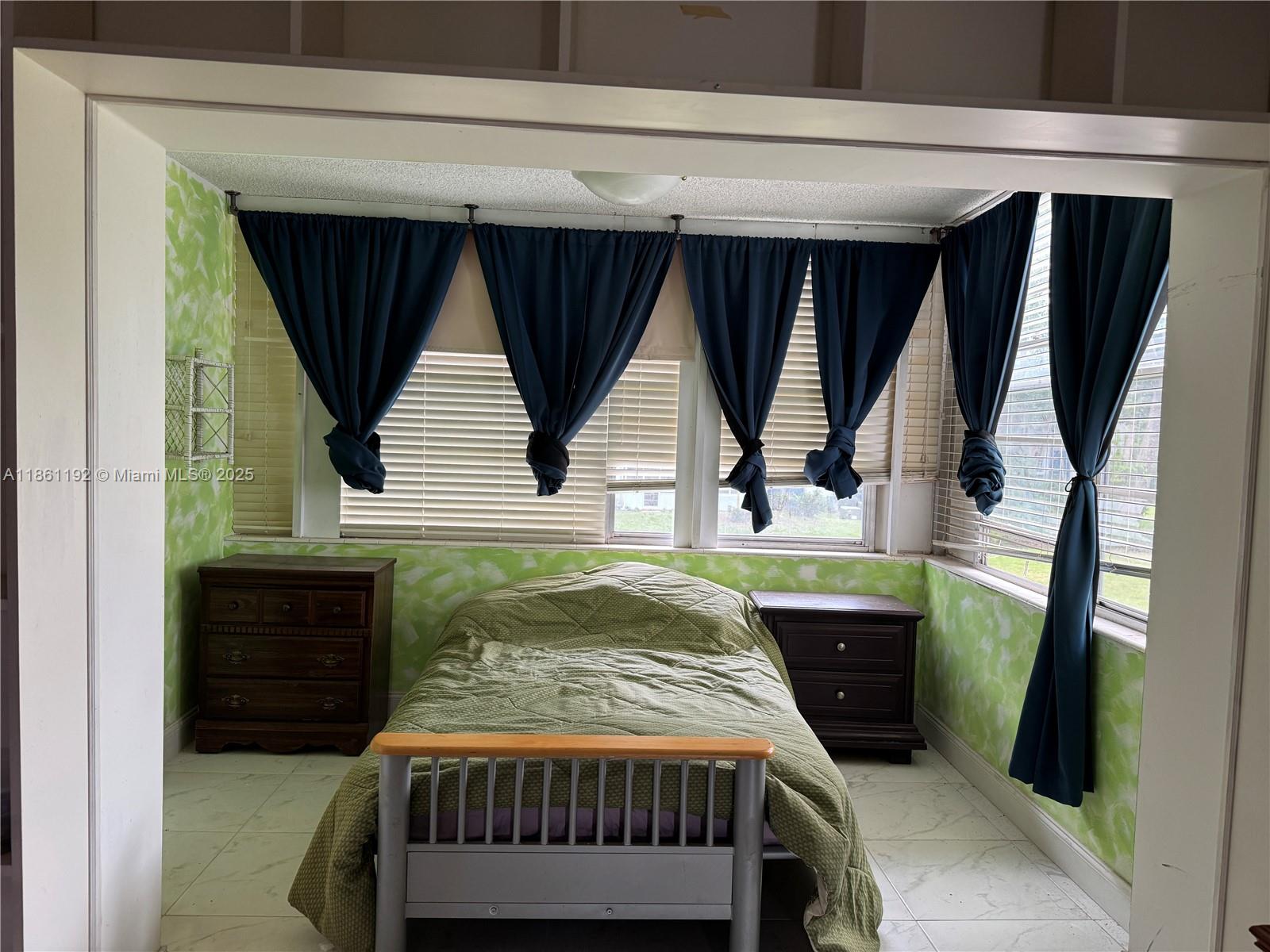 3090 Holiday Springs Boulevard, Unit 206 Margate, FL 33063 - Photo 19 of 41 a bedroom with a bed next to a window