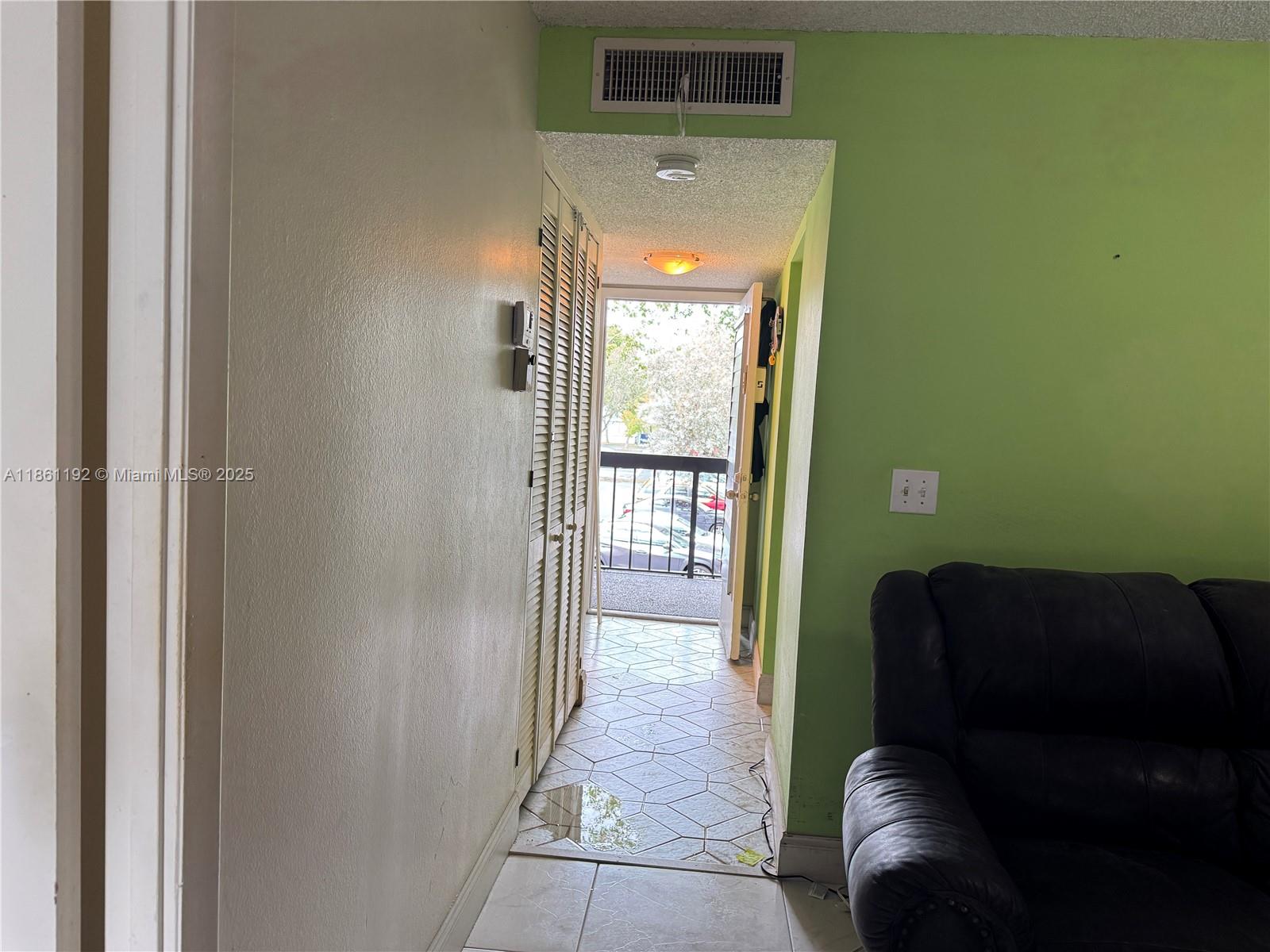 3090 Holiday Springs Boulevard, Unit 206 Margate, FL 33063 - Photo 20 of 41 a living room with furniture and a gate