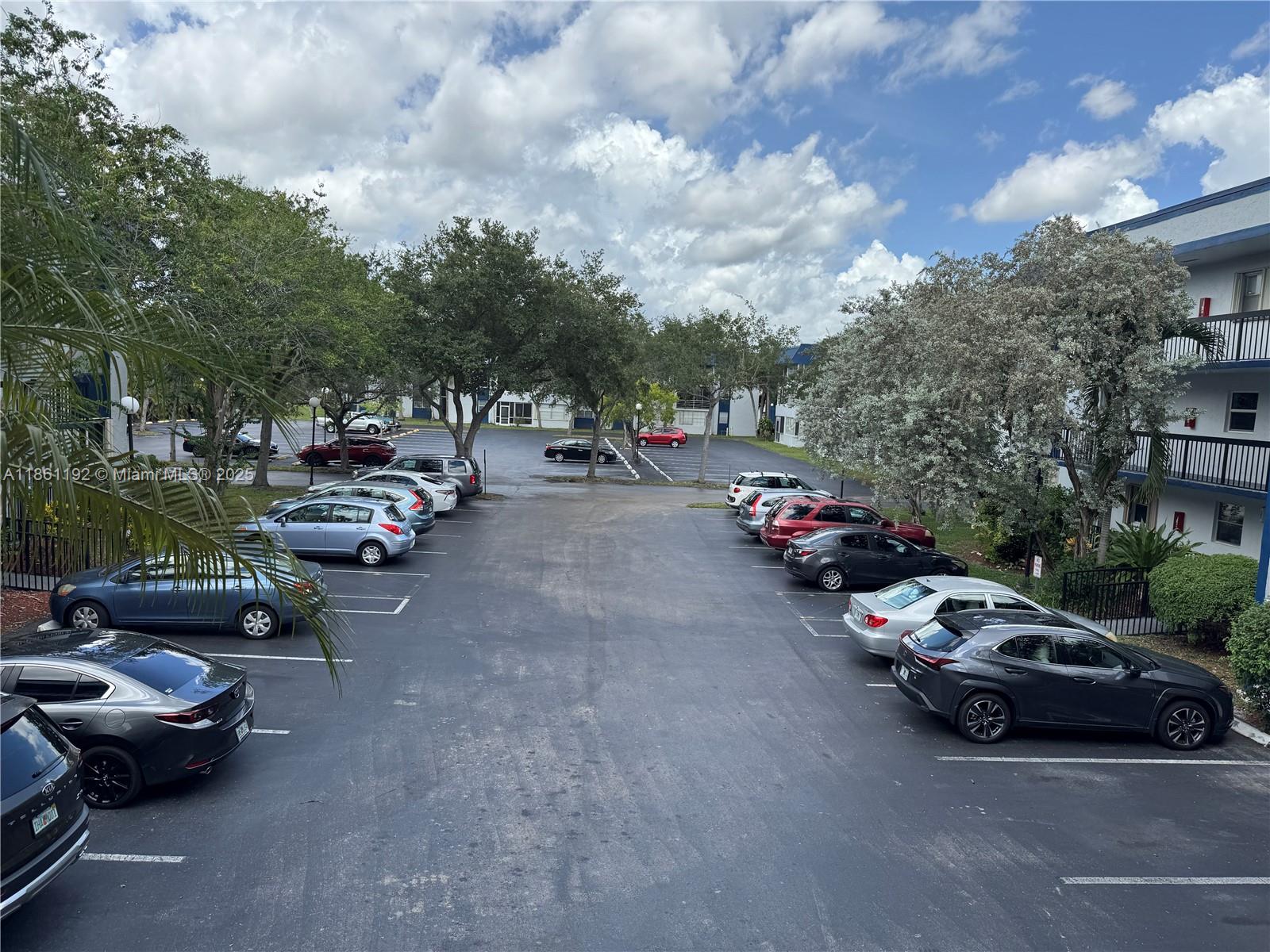 3090 Holiday Springs Boulevard, Unit 206 Margate, FL 33063 - Photo 2 of 41 a view of a street with cars park